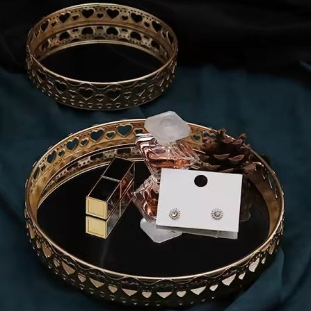 Jewelry set including bangles, earrings, and a perfume bottle on a dark surface.