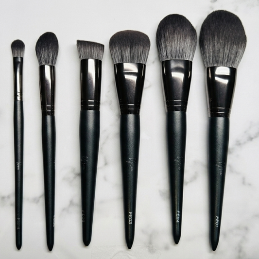Set of makeup brushes on a marble surface