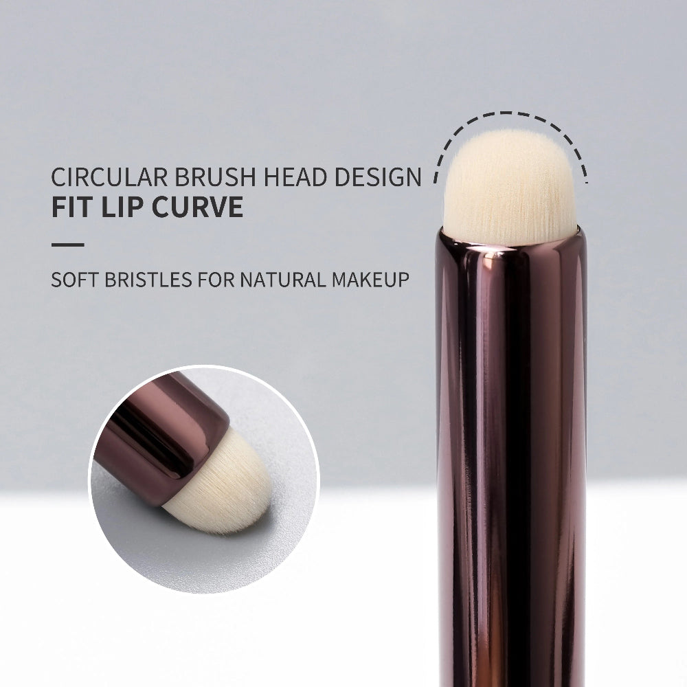 Lipstick brush with circular brush head design on a gray background