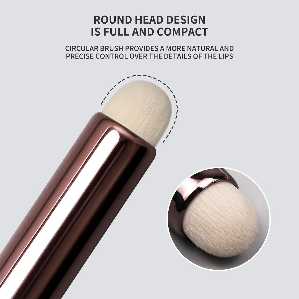 Makeup brush with round head design on a light gray background