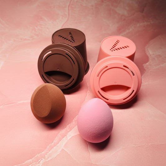 Set of pink and brown makeup sponges on a pink textured background